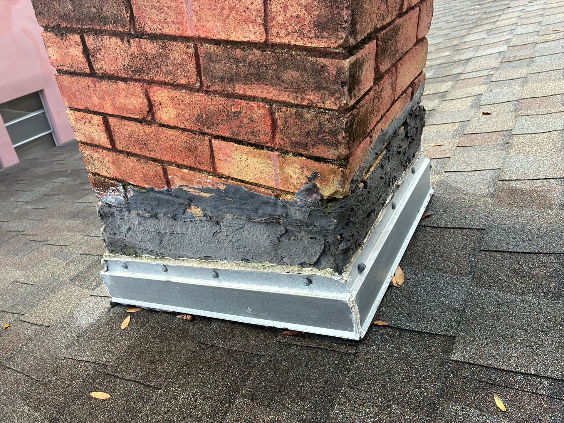 Damaged, substandard flashing at the base of a brick chimney found during a Tampa home inspection