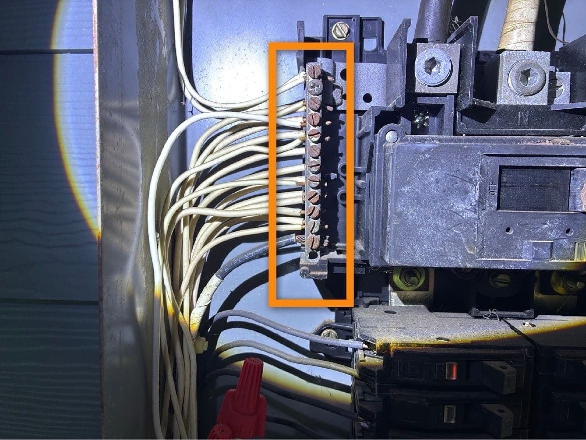 Electrical panel with multiple neutral wires on one terminal, highlighted during a Tampa home inspection