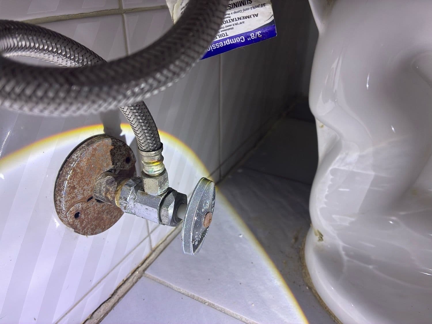 Galvanized supply plumbing at a toilet supply valve.